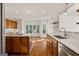 Bright kitchen featuring wood cabinetry, countertops, and windows overlooking the backyard at 3860 Bays Ferry Trl, Marietta, GA 30062