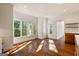 Bright and airy living room features hardwood flooring, large windows, and views of the surrounding greenery at 3860 Bays Ferry Trl, Marietta, GA 30062