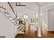 Bright living room featuring hardwood floors, columns, a staircase, and large windows at 3860 Bays Ferry Trl, Marietta, GA 30062