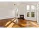 Bright living room with hardwood floors, fireplace, ceiling fan, and large windows at 3860 Bays Ferry Trl, Marietta, GA 30062