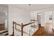 Hardwood staircase showcasing white walls and wooden railings, with a hanging light at 3860 Bays Ferry Trl, Marietta, GA 30062