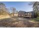 Backyard view shows a house, fenced yard, and detached garage, offering outdoor privacy and space at 3006 Deshong Dr, Stone Mountain, GA 30087