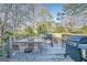 Backyard deck with patio table, chairs, and two grills overlooking the yard at 3006 Deshong Dr, Stone Mountain, GA 30087