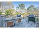 Backyard deck with a patio table, chairs, and two grills great for entertaining at 3006 Deshong Dr, Stone Mountain, GA 30087
