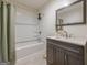 Well-lit bathroom featuring a shower-tub combo and stylish vanity with modern fixtures at 3006 Deshong Dr, Stone Mountain, GA 30087