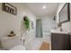 Bright bathroom featuring a shower-tub combo, decorative accents, and a tiled floor at 3006 Deshong Dr, Stone Mountain, GA 30087