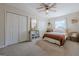 Cozy bedroom featuring two closets, a ceiling fan, and natural light from the window at 3006 Deshong Dr, Stone Mountain, GA 30087