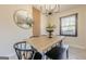 Modern dining room featuring a light wood table, black chairs, and a contemporary chandelier at 3006 Deshong Dr, Stone Mountain, GA 30087