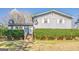 Charming two-story home with light blue siding and white trim surrounded by green hedges at 3006 Deshong Dr, Stone Mountain, GA 30087