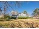 Spacious two-story home with a well-manicured lawn and mature trees, creating a serene setting at 3006 Deshong Dr, Stone Mountain, GA 30087