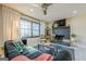 Cozy living room featuring a dark sofa, brick fireplace, and large window with natural light at 3006 Deshong Dr, Stone Mountain, GA 30087