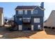 View of the backyard with a small deck and walk out basement at 9989 Village South Dr, Douglasville, GA 30135