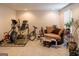 Basement exercise area, featuring fitness equipment and cozy sitting space with a loveseat at 9989 Village South Dr, Douglasville, GA 30135