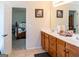 Bathroom with double vanity and access door to the main bedroom at 9989 Village South Dr, Douglasville, GA 30135