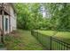 Scenic backyard featuring lush greenery and a black fence, offering a private outdoor space at 1972 Cox Dr, Austell, GA 30168