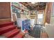 Well-organized basement area with stairs leading to laundry and storage space at 1972 Cox Dr, Austell, GA 30168