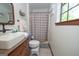 Updated bathroom featuring a pedestal sink, tiled flooring, and a shower with new fixtures at 1972 Cox Dr, Austell, GA 30168