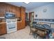 Traditional kitchen design with tiled floors, white appliances, and breakfast table at 1972 Cox Dr, Austell, GA 30168