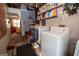Functional laundry area featuring washer, dryer, shelving and convenient access to other living spaces at 1972 Cox Dr, Austell, GA 30168