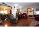 Inviting living room with hardwood floors, piano, and views of the dining area at 1972 Cox Dr, Austell, GA 30168