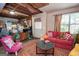 Inviting living room with colorful rug, comfortable red sofa and eclectic furnishings at 1972 Cox Dr, Austell, GA 30168