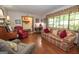 Sun-drenched living room featuring a fireplace, hardwood floors and large window at 1972 Cox Dr, Austell, GA 30168