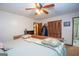 Relaxing main bedroom featuring a ceiling fan, ensuite bath, and a spacious closet at 1972 Cox Dr, Austell, GA 30168