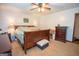 Sizable main bedroom with neutral walls, a ceiling fan, and a wooden sleigh bed at 1972 Cox Dr, Austell, GA 30168