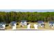An aerial view showcases newly constructed homes with lush green landscaping on a large lot at 201 Friendship Oak Way, Hampton, GA 30228