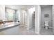 Bright bathroom featuring a walk-in shower, toilet and storage space at 201 Friendship Oak Way, Hampton, GA 30228