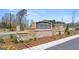 The stone community entrance sign reads 'Oakchase at Hampton' amidst manicured landscaping at 201 Friendship Oak Way, Hampton, GA 30228