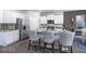Bright kitchen featuring granite counters, stainless steel appliances, and eat-in breakfast bar at 201 Friendship Oak Way, Hampton, GA 30228