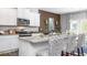 Kitchen featuring granite counters, white cabinets, stainless appliances, and breakfast bar at 201 Friendship Oak Way, Hampton, GA 30228