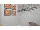 A bright laundry room with decorative artwork and storage shelves at 201 Friendship Oak Way, Hampton, GA 30228