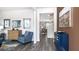 A stylish living room featuring hardwood floors and a blue accent chair at 201 Friendship Oak Way, Hampton, GA 30228