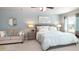 Spacious main bedroom featuring plush carpet, sitting area, and natural light at 201 Friendship Oak Way, Hampton, GA 30228