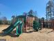 Community playground featuring multiple slides and climbing structures on a wood chip surface at 201 Friendship Oak Way, Hampton, GA 30228