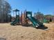 Community playground featuring multiple slides and climbing structures with mature trees at 201 Friendship Oak Way, Hampton, GA 30228