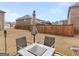 Outdoor dining setup under an umbrella, next to a privacy fence for outdoor gathering at 445 Sawmill Trce, Hampton, GA 30228