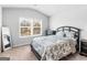 Bedroom showcasing a bed, side tables, and a large window for natural light, and neutral colors at 445 Sawmill Trce, Hampton, GA 30228