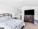 Bedroom featuring a bed, dresser, and doorway to the hallway leading to the staircase at 445 Sawmill Trce, Hampton, GA 30228