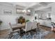 Elegant dining area with a stylish chandelier, wainscoting, and an open concept design at 445 Sawmill Trce, Hampton, GA 30228