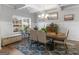 Bright dining room featuring a window, bench seating, and stylish blue area rug at 445 Sawmill Trce, Hampton, GA 30228