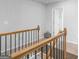 Hallway features a decorative wooden railing and neutral wall colors, creating a welcoming space at 445 Sawmill Trce, Hampton, GA 30228