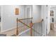 Upstairs hallway showcasing a decorative wooden railing and neutral wall colors, creating a welcoming space at 445 Sawmill Trce, Hampton, GA 30228