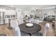 View of eat-in-kitchen next to dining table, granite countertop, and open floorplan at 445 Sawmill Trce, Hampton, GA 30228