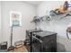 Functional laundry room with washer and dryer, overhead shelving, and natural light at 445 Sawmill Trce, Hampton, GA 30228