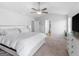 Main bedroom boasts a ceiling fan, carpet flooring, and neutral paint at 445 Sawmill Trce, Hampton, GA 30228