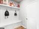 Well-organized mudroom with built-in storage bench, hooks, and shelving, keeping everything tidy and accessible at 445 Sawmill Trce, Hampton, GA 30228