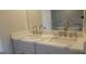 Bathroom featuring a double sink vanity, elegant fixtures, granite countertops, and a bathtub visible in the mirror at 2085 Dellwood Pl, Decatur, GA 30032